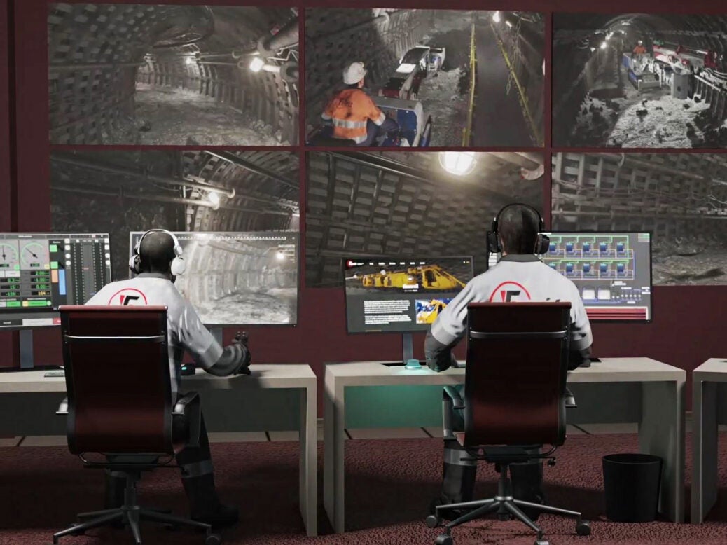 View of a mine's digital control room with two operators