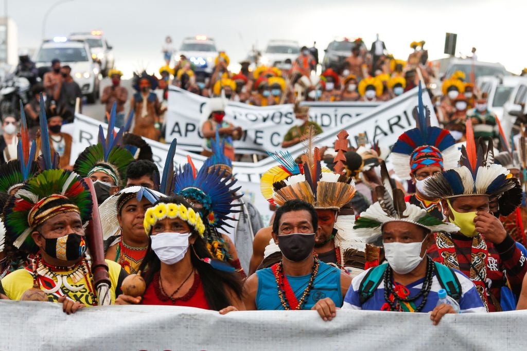 Brazilian indigenous people protest against Bill 490, which halts demarcation and opens indigenous lands to mining, outside the Federal Supreme Court in Brasilia, on June 14, 2021
