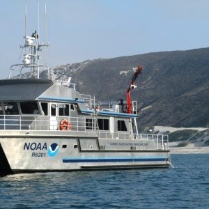 Shearwater, a silver NOAA vessel, on the sea.