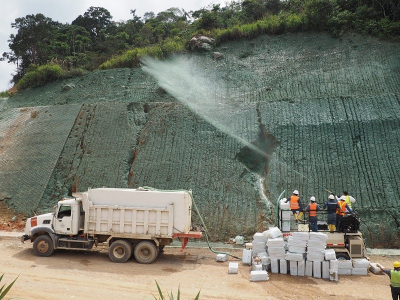 A metered water truck applies NaturesOwn Knockout Dust Suppressant to a high trafficked road.